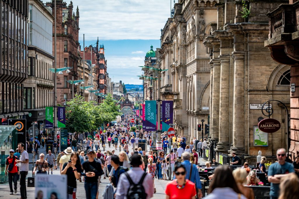 High street shoppers on a busy street in Glasgow summer 2018